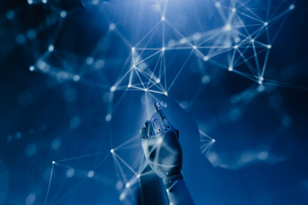 A robotic hand reaching towards a glowing network of connected nodes, representing frontier AI systems