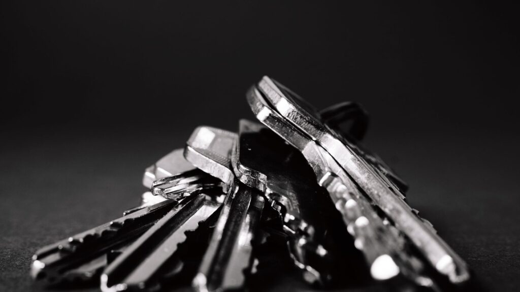 Close-up of a bunch of metal keys on a dark surface, representing cryptographic key management