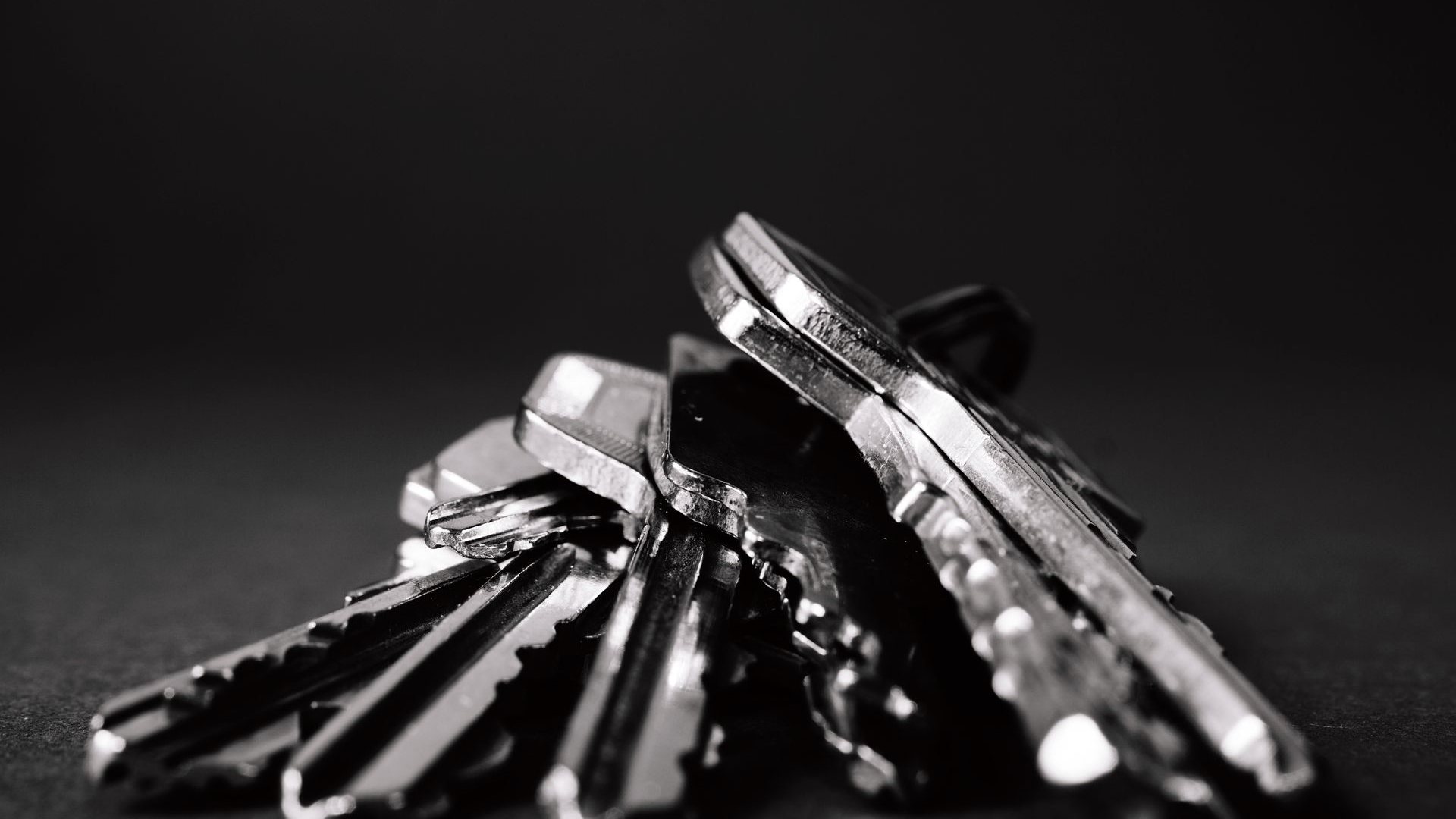 Close-up of a bunch of metal keys on a dark surface, representing cryptographic key management